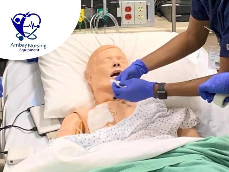 Nursing students practicing skills on a basic nursing manikin